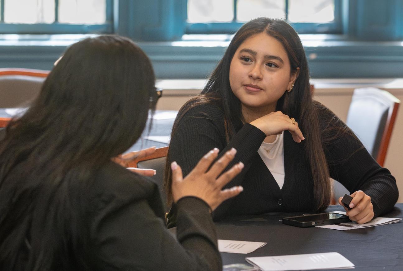 Students sitting across from each other at a table