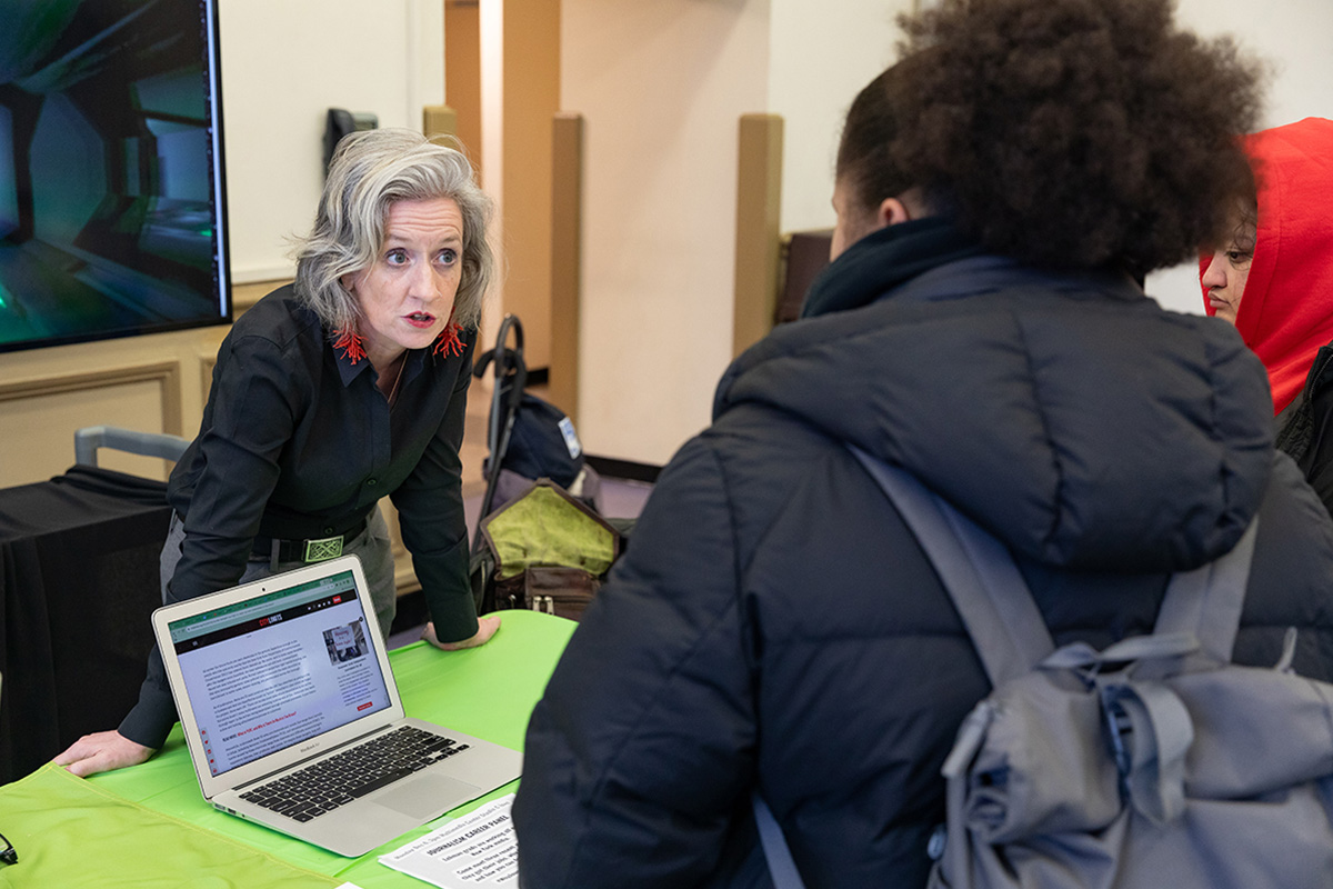 Photo of student talking to a member of the staff