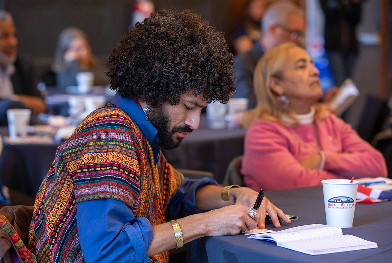 Person taking notes while sitting at table