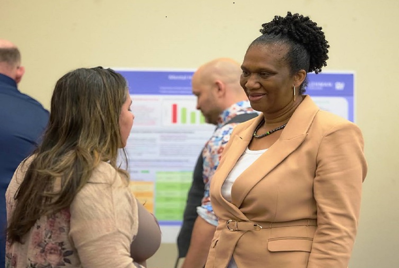 ladies talking with chart on background