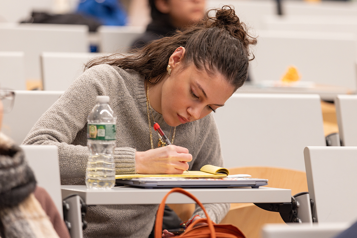 Photo of student writing on her notebook
