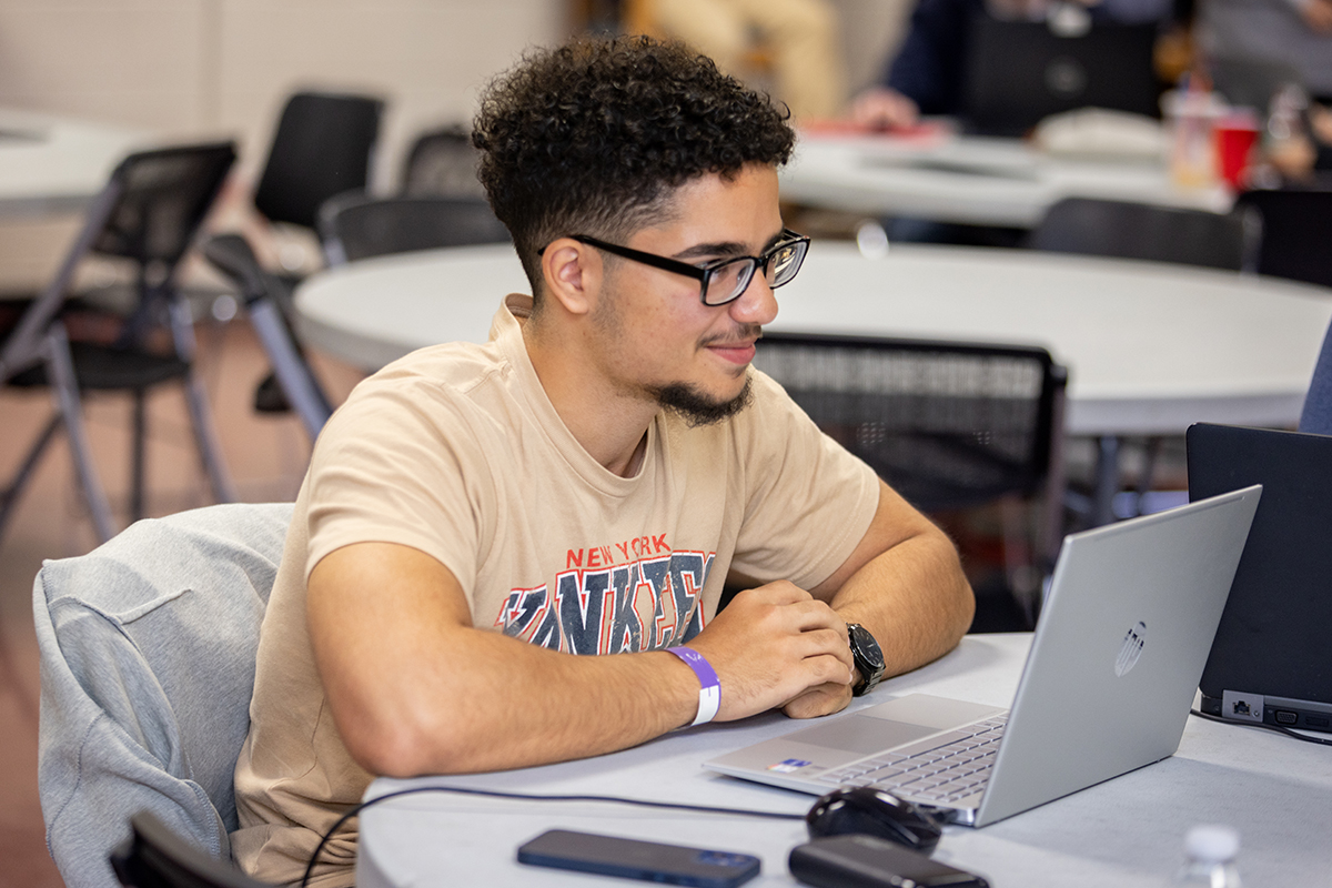 Student sitting looking at computer
