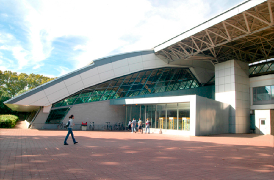 Courtyard in front of a modern building with people.