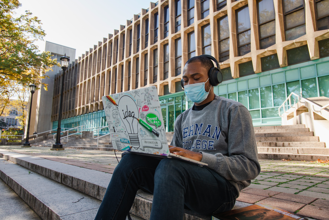 Student sitting on campus with Laptop