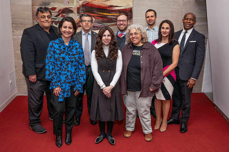 A diverse group of faculty members pose for the camera with President Delgado and Provost Nwosu.