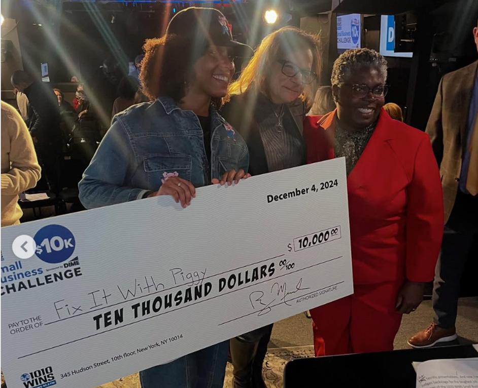 Ashanda Culcleasure holds up a giant check for $10,000