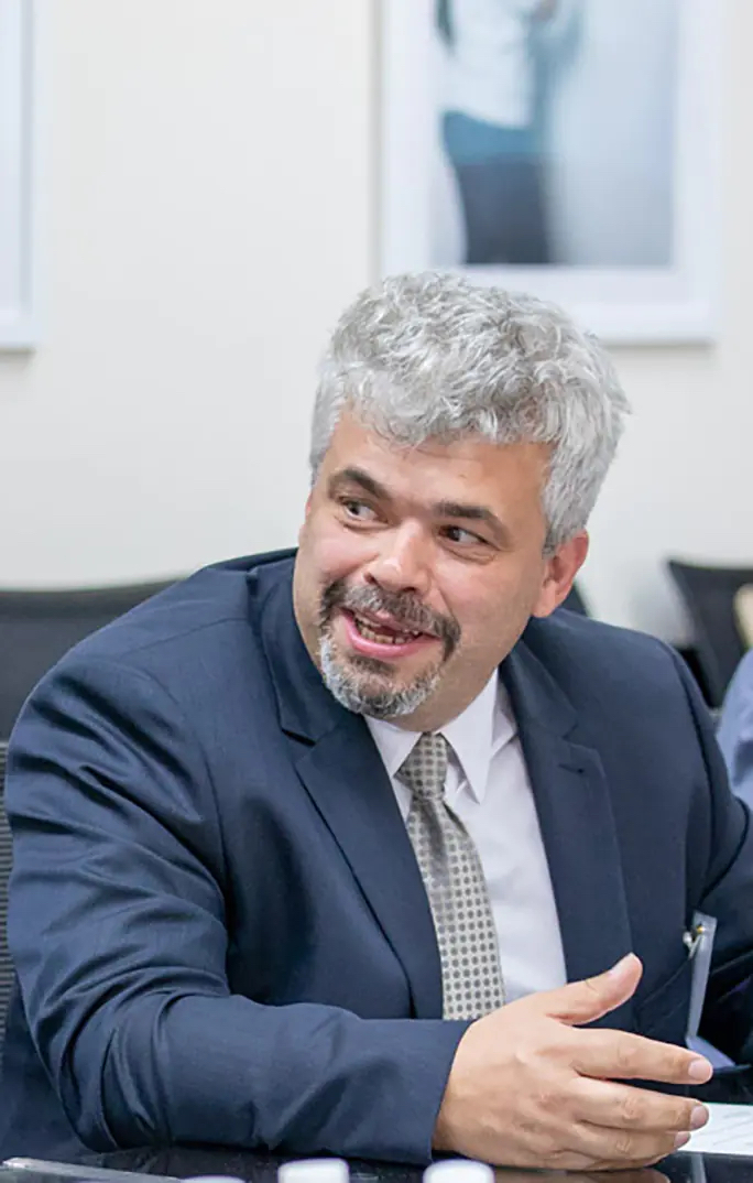 Andrei Jitianu sitting at a table speaking.