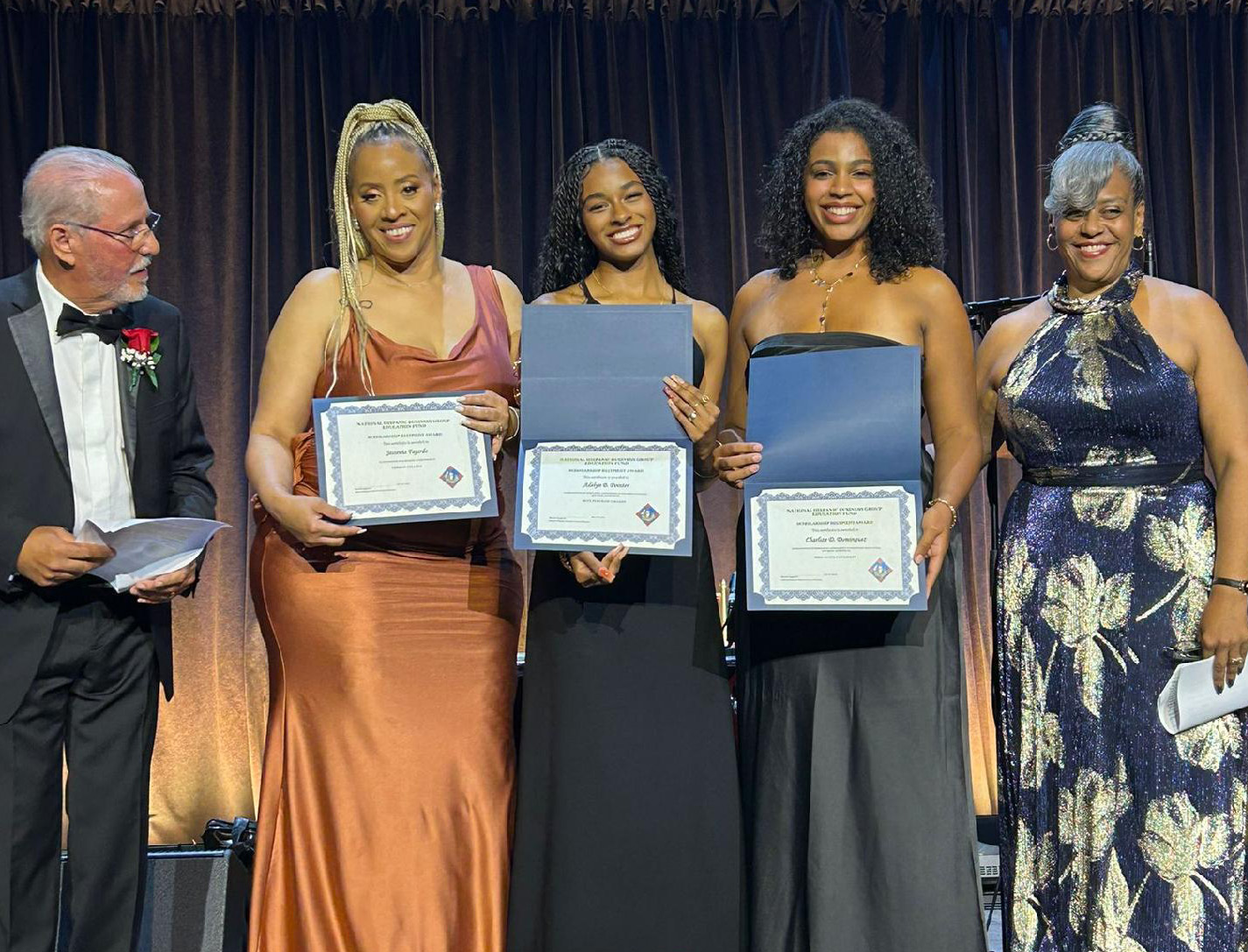 Jessenia Fajardo, second from left, and two other scholarship winners onstage at Cipriani Wall Street.