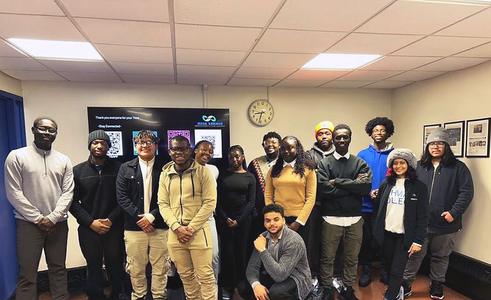 A group of students posing for the camera indoors.