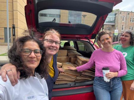Renuka Sankaran and colleagues from the New York Botanical Garden pose with a car full of specimens in folders