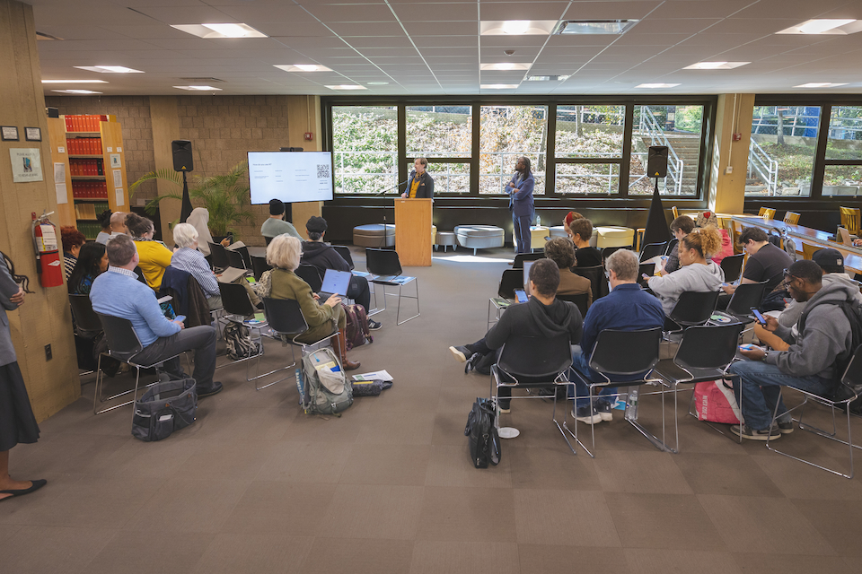Corey Ptak presents to a group of students and faculty.