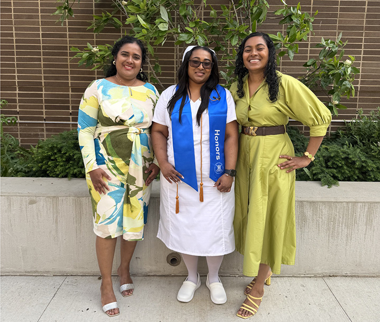 Rosanna, Arlene, and Andrea Ramsudh pose after the Department of Nursing pinning ceremony. Arlene is in a nurse's uniform.