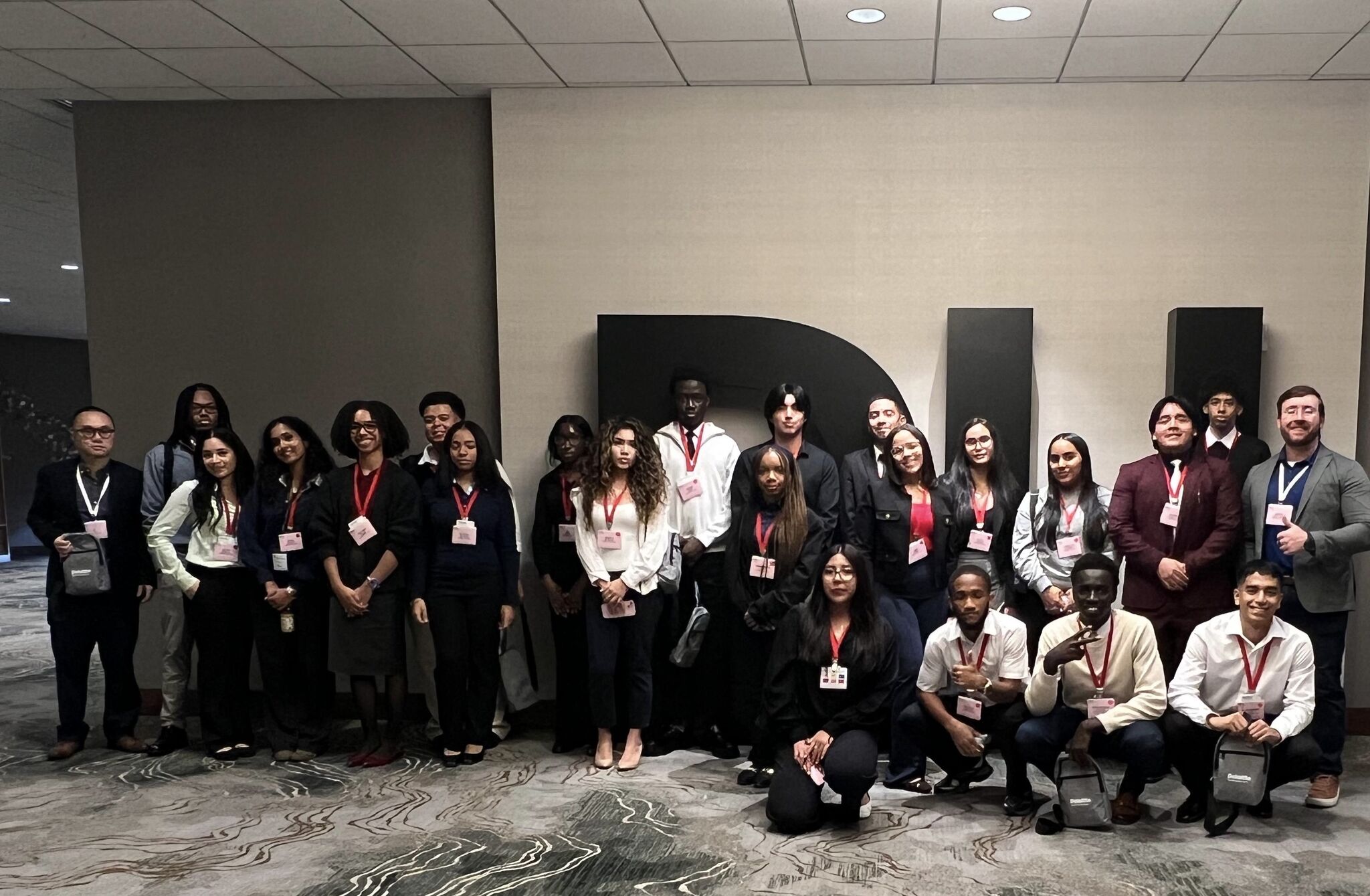 A group of students and faculty advisor Sean Stein Smith at Deloitte Headquarters