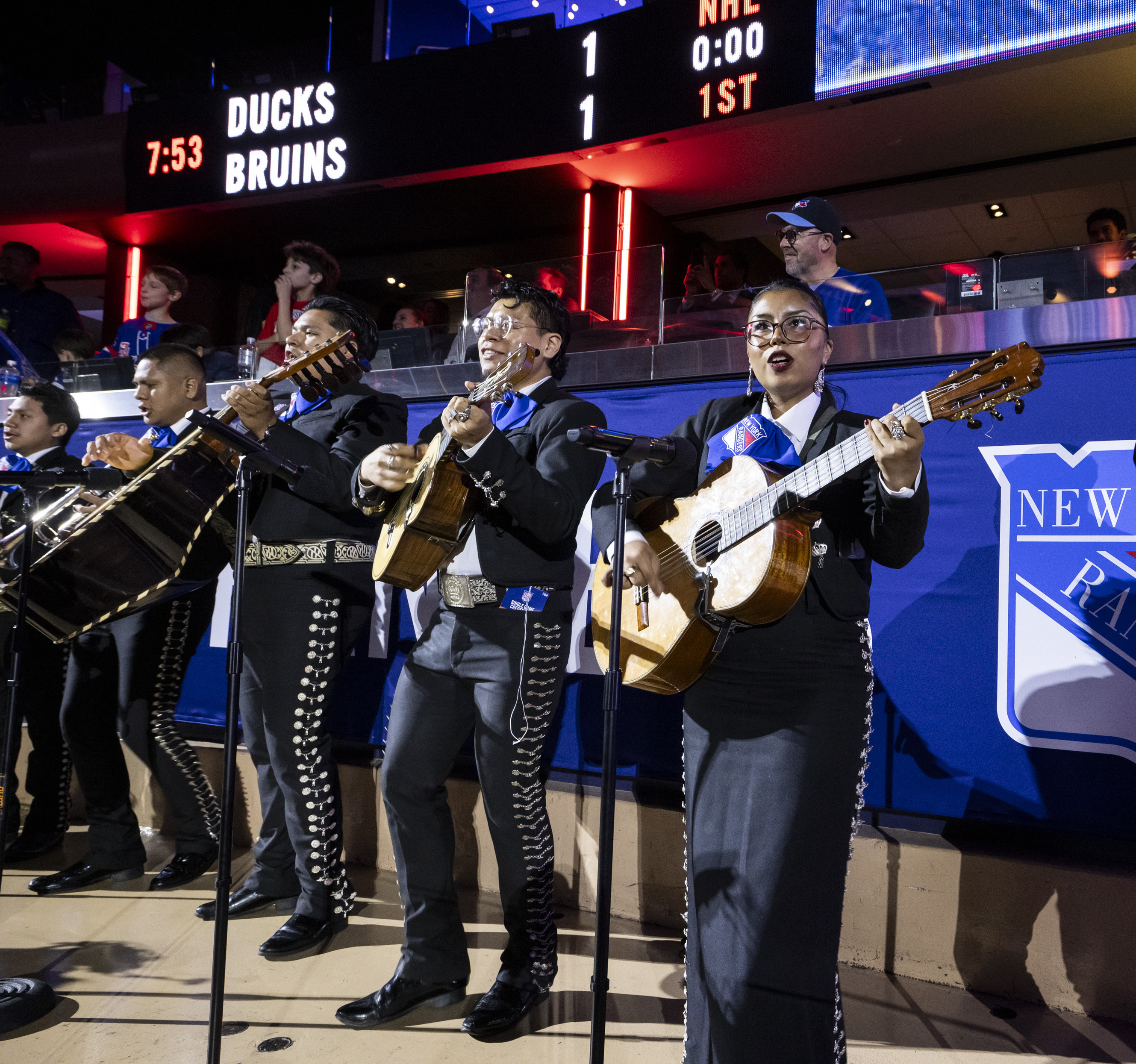 A mariachi band playing at a Madison Square Garden hockey game.