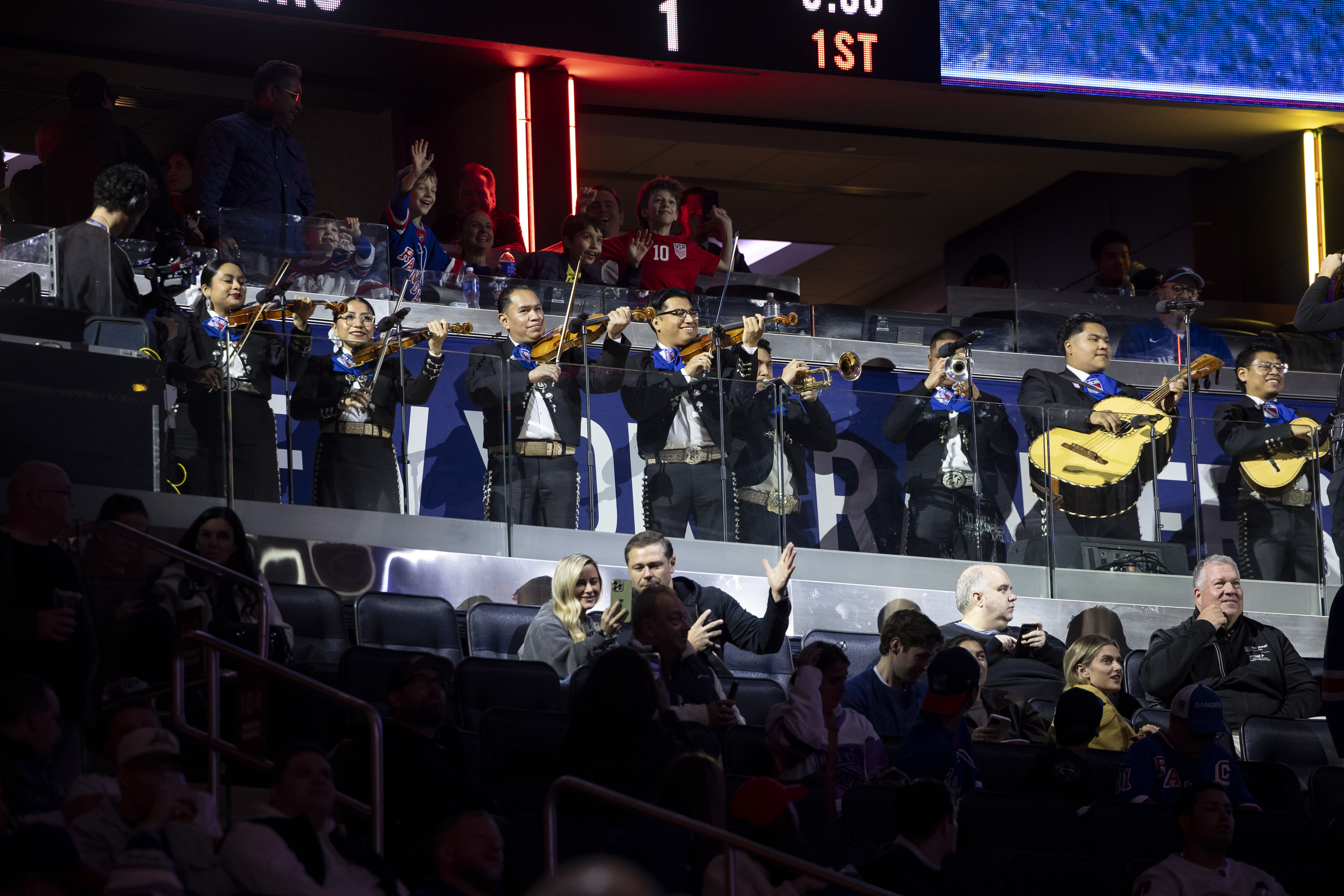 A mariachi band playing at a Madison Square Garden hockey game.