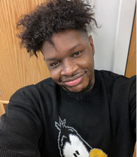 Student Smiling with a black sweater on