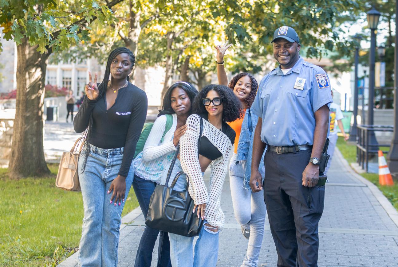 Students with a public safety officer smiling