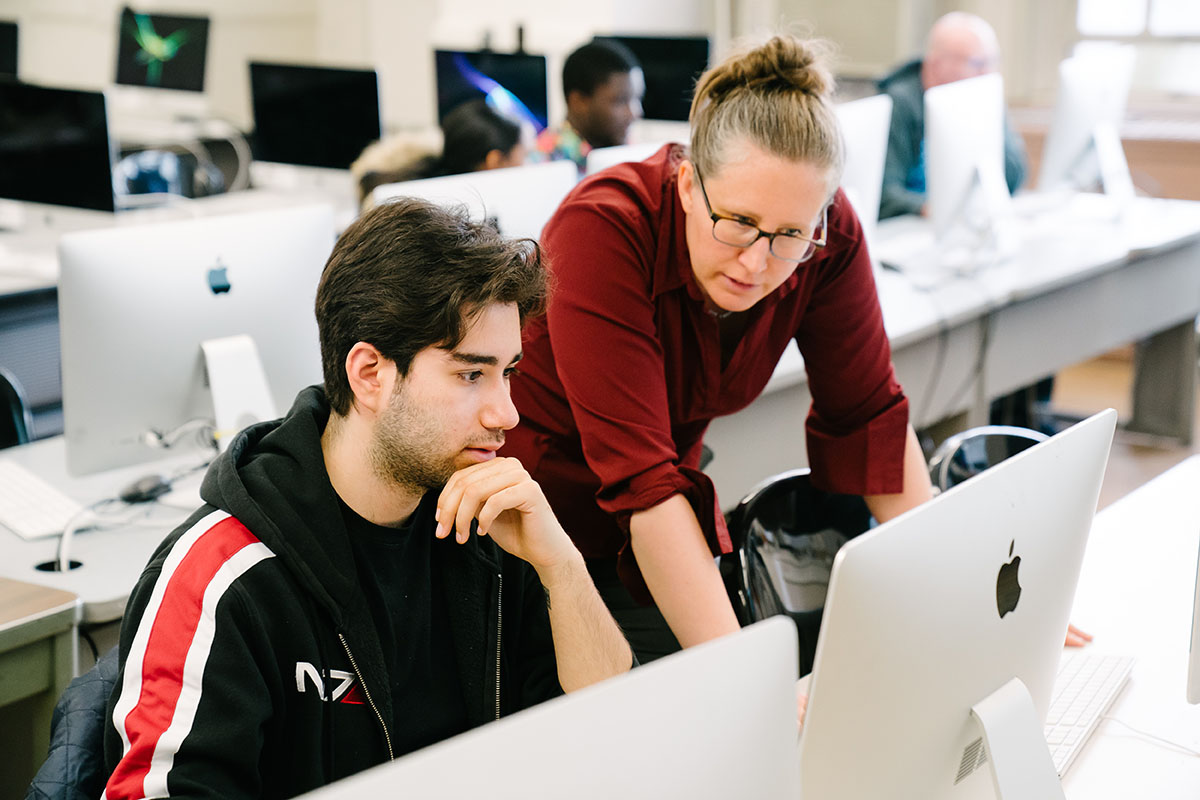 Photo of students and professor in computer lab