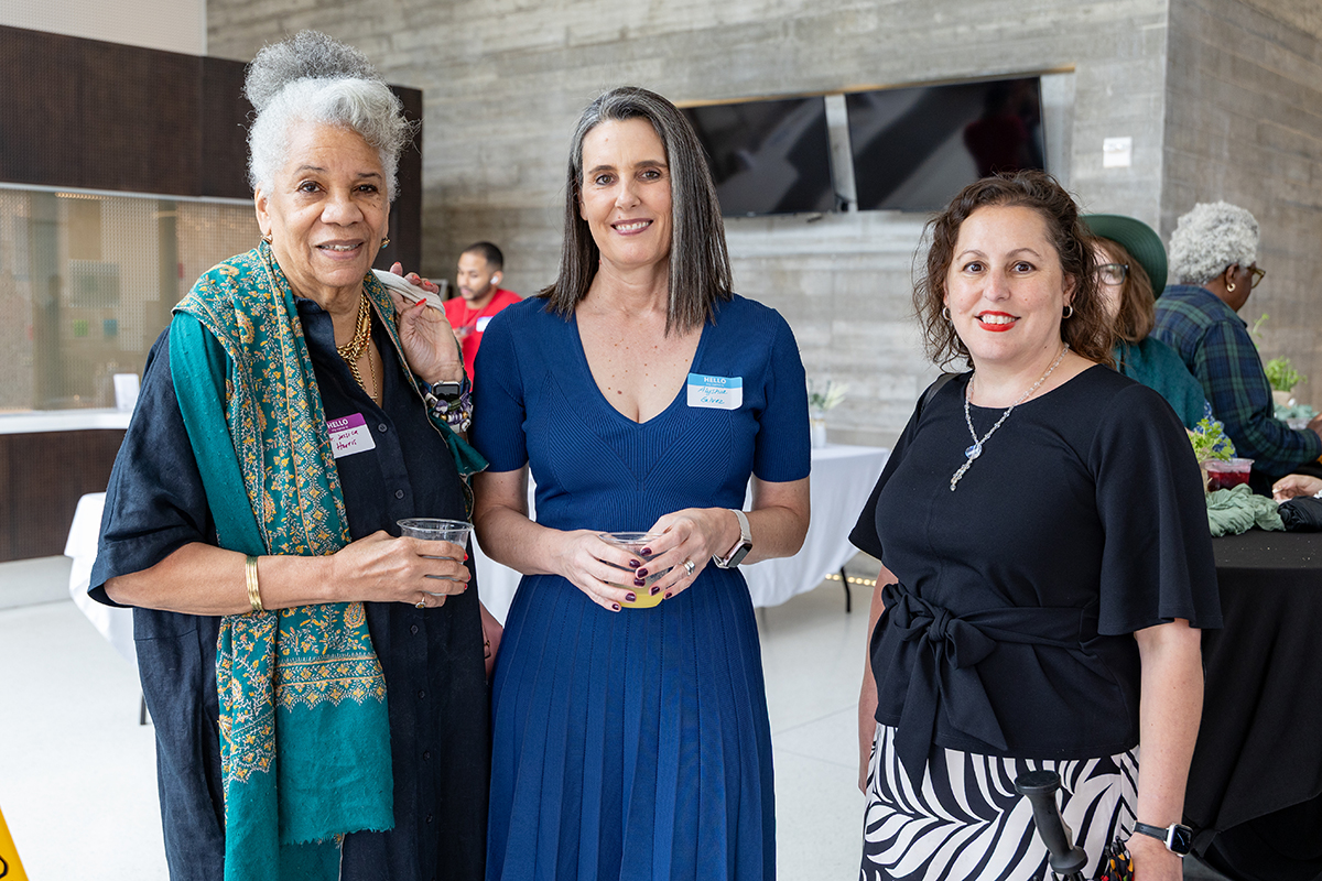 Three staff members smiling together at Food Humanities Program Launch Event