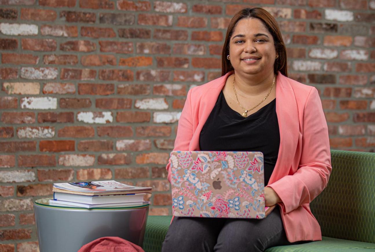 Adult Student sitting on a couch on the computer