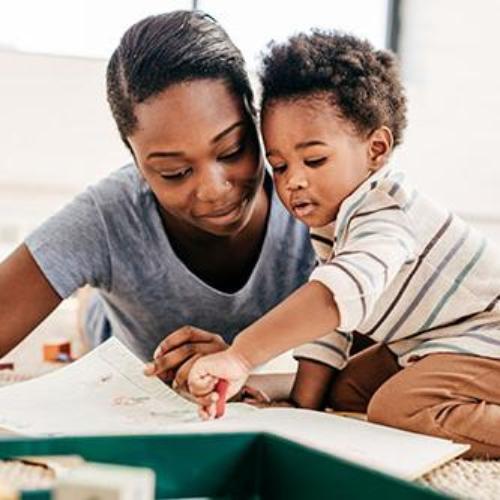 Literacy Early Childhood and Childhood Education Student reading to a toddler